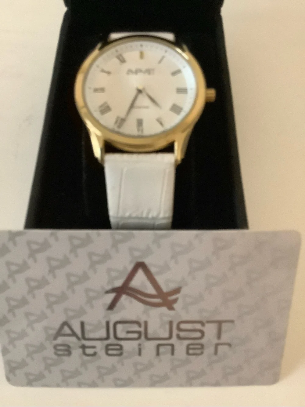 August Steiner diamond watch. New. White leather band.